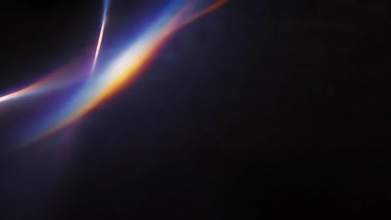 Streaks of blue, orange and purple light on a dark background
