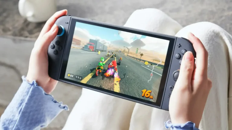 Hands holding a Nintendo Switch 2 in handheld mode, with a kart race on the screen