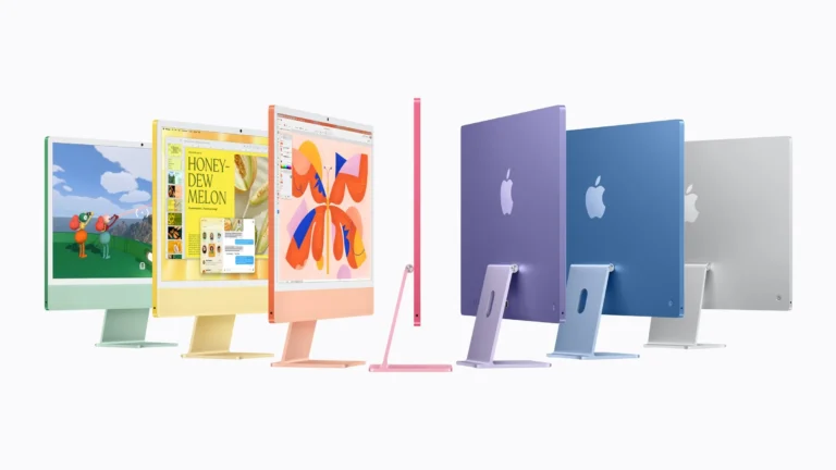 Seven iMac with M6 models in green, yellow, orange, pink, purple, blue and silver, some facing forward and some turned to show their backs