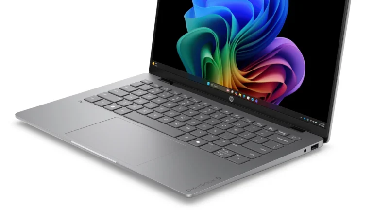 An HP OmniBook 5 14-inch laptop in silver, open at an angle, with its keyboard and the lower half of its screen in view