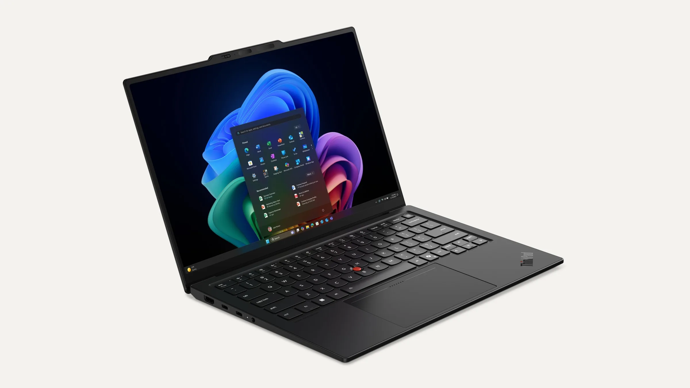A black Lenovo ThinkPad X1 Carbon Gen 14 laptop, open and angled to the right, with the Windows 11 Start menu on its screen.